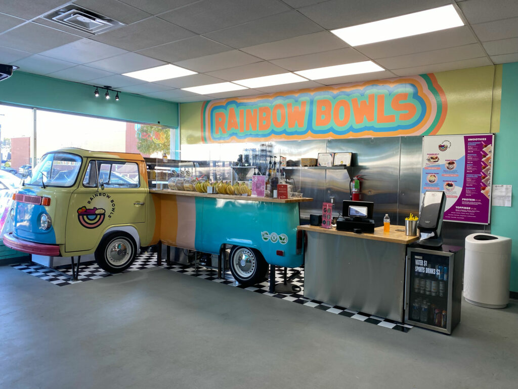 Vehicle wrap on a 1973 VW Van that was converted to a retail counter. Logo name wall wrap above the counter.